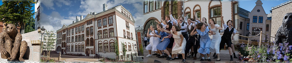 en gruppe mennesker som poserer for et bilde foran en bygning